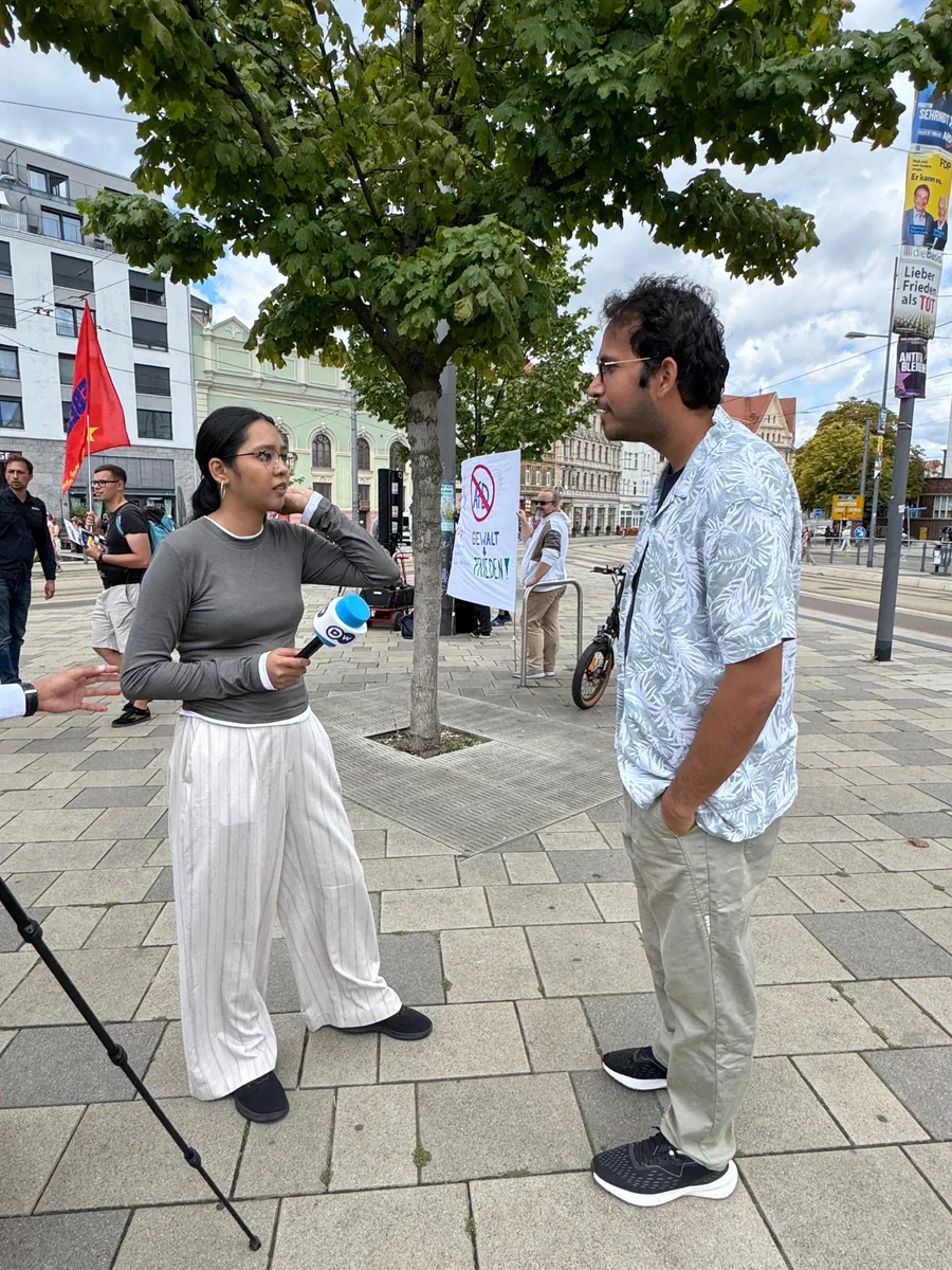 P. K. Tiwari being interviewed by Deutsche Welle at a demonstration