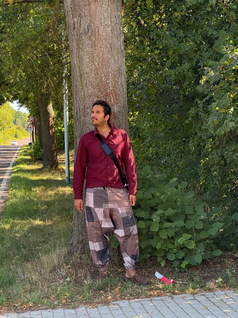 P. K. Tiwari standing against a roadside tree